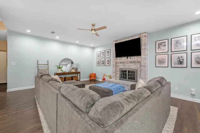 a living room with fireplace furniture and a flat screen tv