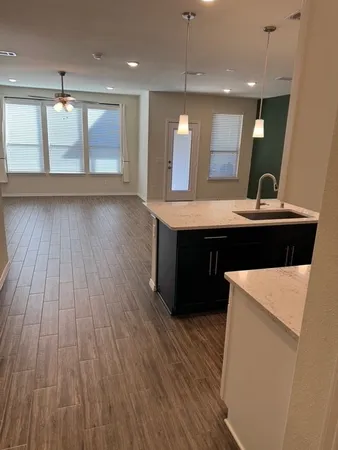 a open kitchen with kitchen island a sink dishwasher a refrigerator and wooden floor