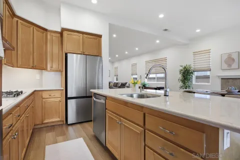a kitchen with stainless steel appliances a refrigerator sink and cabinets