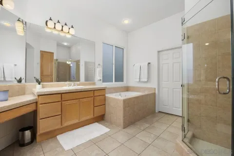 a large bathroom with a sink a large mirror and a shower