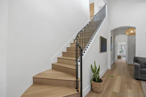 a view of entryway and hall with wooden floor