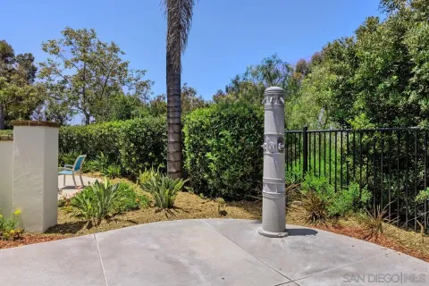 a street sign on a sidewalk next to a road