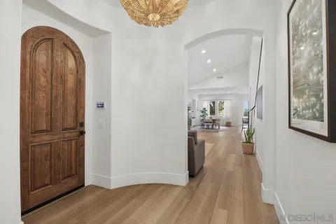 a view of a hallway view with wooden floor and staircase