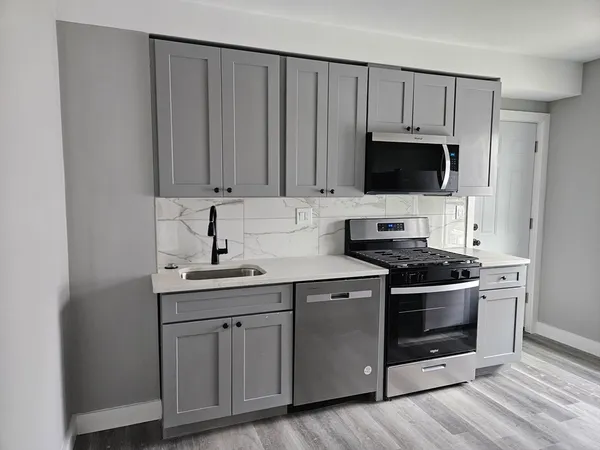 a kitchen with stainless steel appliances granite countertop a stove and a sink