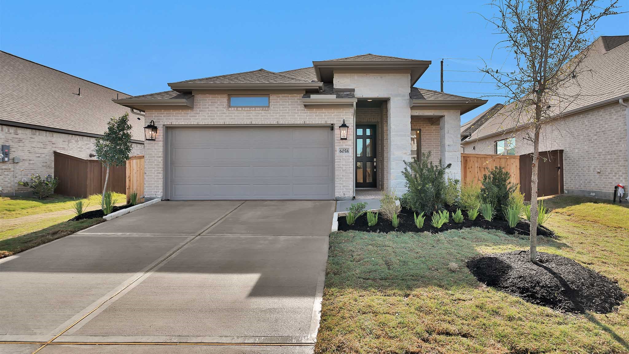 6058 Cottontail Lane Manvel, TX 77578 - Photo 18 of 26 a front view of a house with a yard and garage
