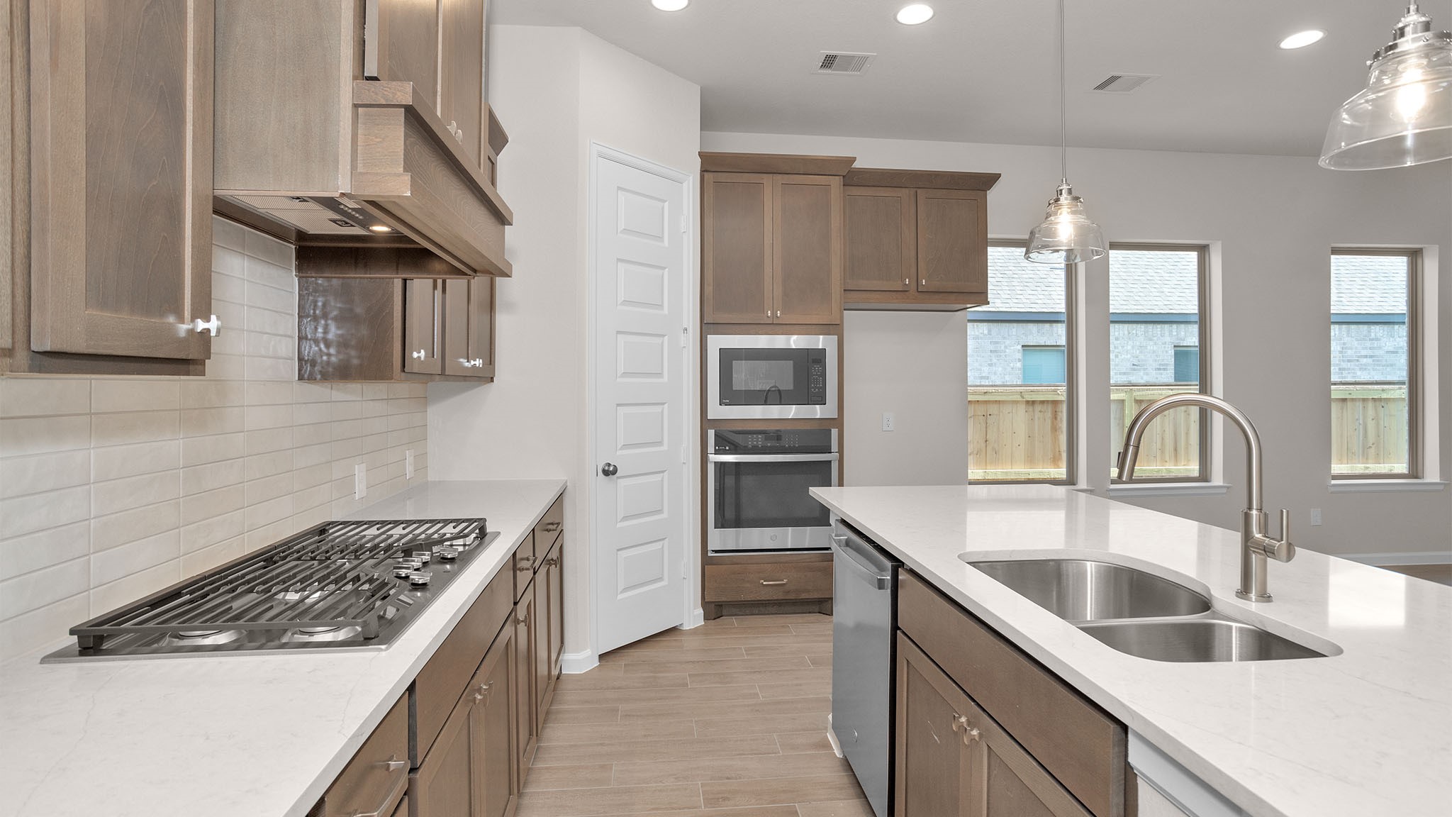 6058 Cottontail Lane Manvel, TX 77578 - Photo 10 of 26 a kitchen with stainless steel appliances granite countertop a sink stove and refrigerator