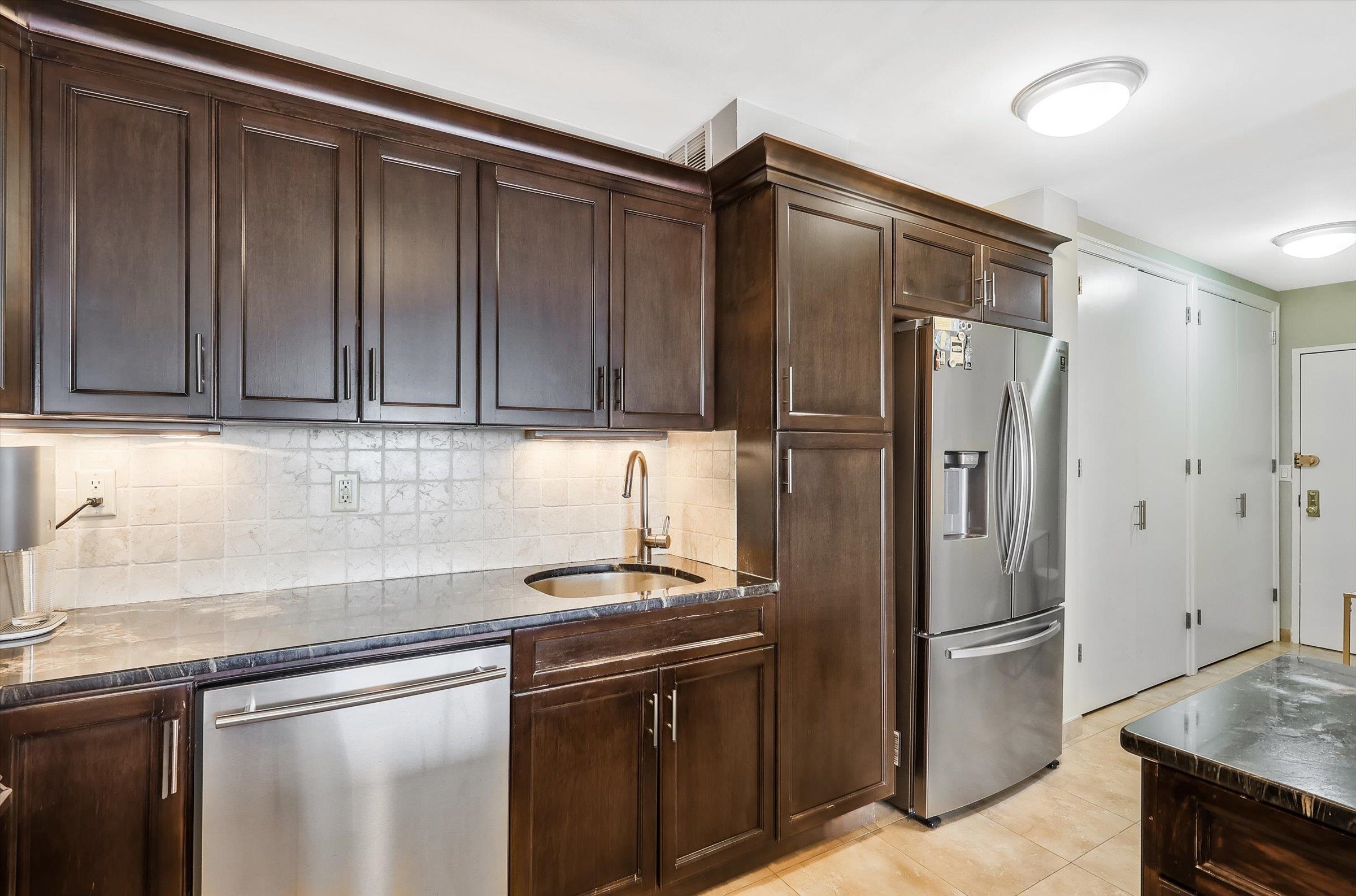 380 Mountain Road, Unit 1015 Union City, NJ 07087 - Photo 19 of 43 a kitchen with stainless steel appliances granite countertop a refrigerator and a sink