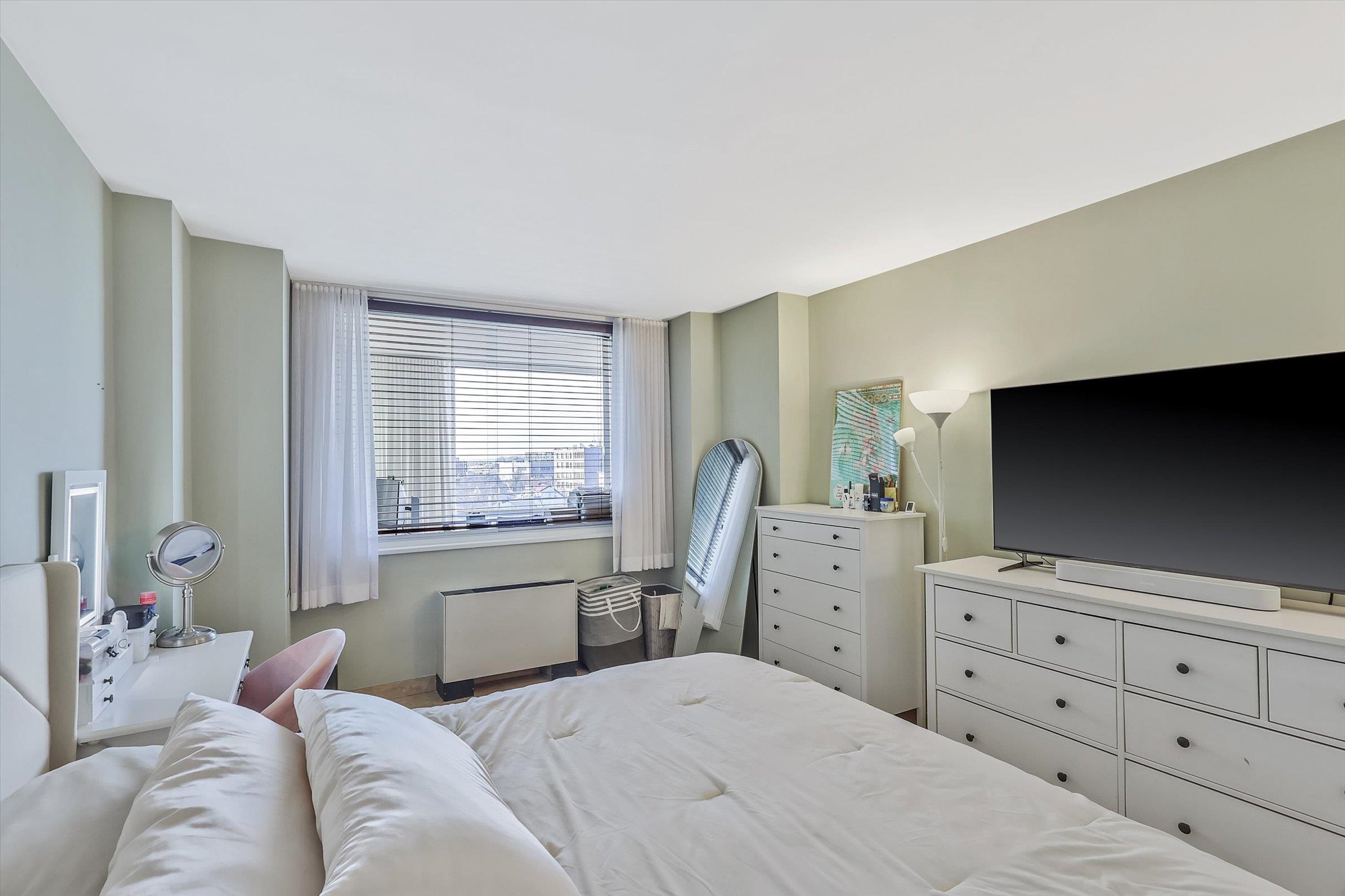 380 Mountain Road, Unit 1015 Union City, NJ 07087 - Photo 22 of 43 a bedroom with a bed and flat screen tv
