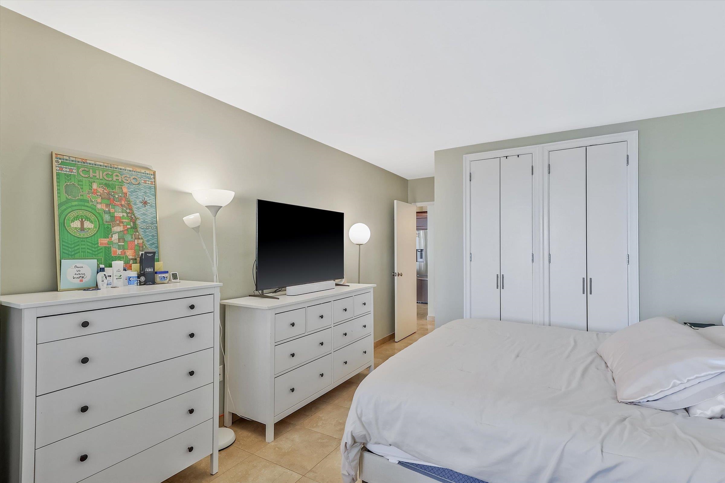 380 Mountain Road, Unit 1015 Union City, NJ 07087 - Photo 24 of 43 a bedroom with a bed and a flat screen tv in a white cabinet