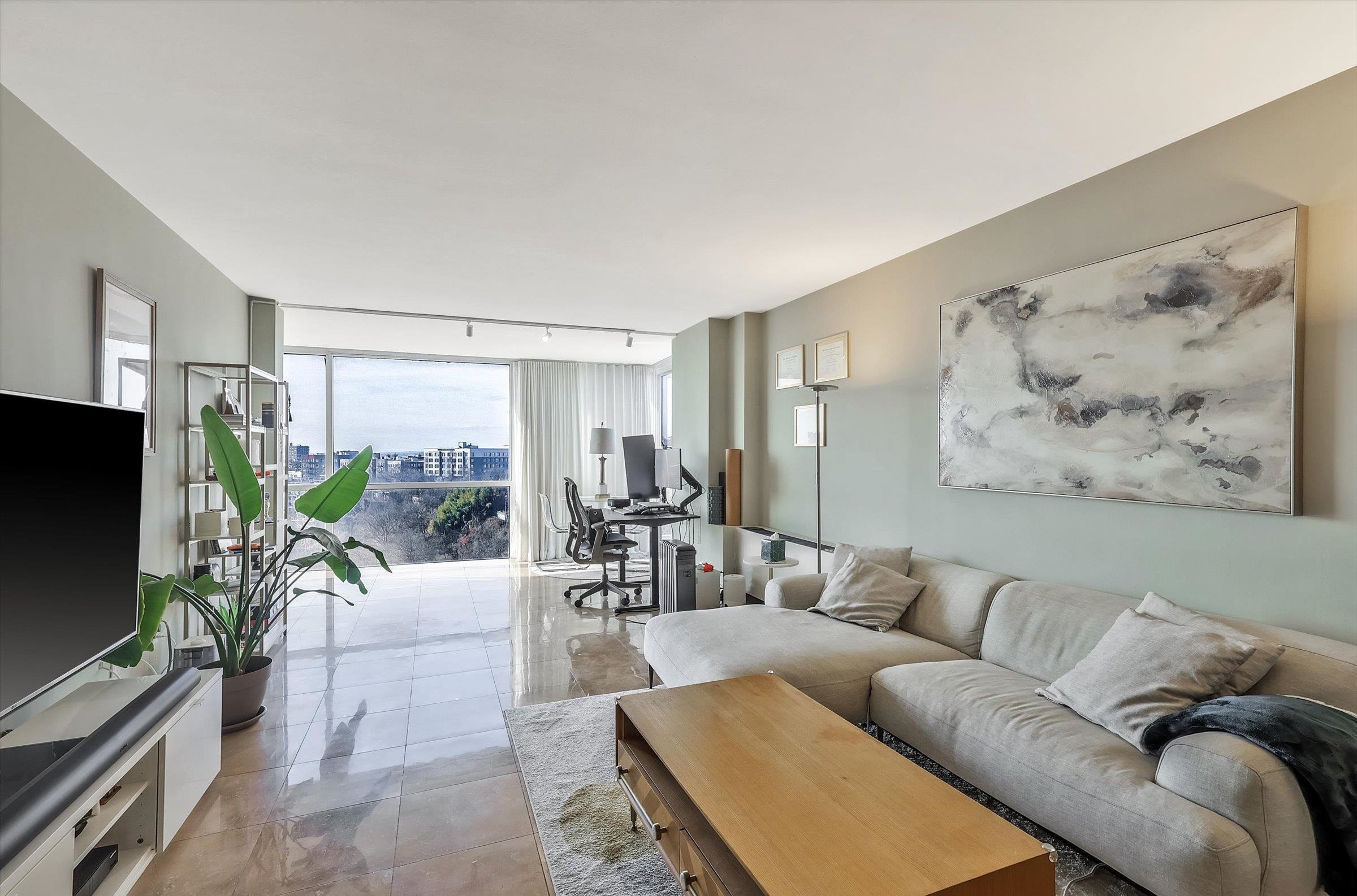 380 Mountain Road, Unit 1015 Union City, NJ 07087 - Photo 3 of 43 a living room with furniture and a flat screen tv