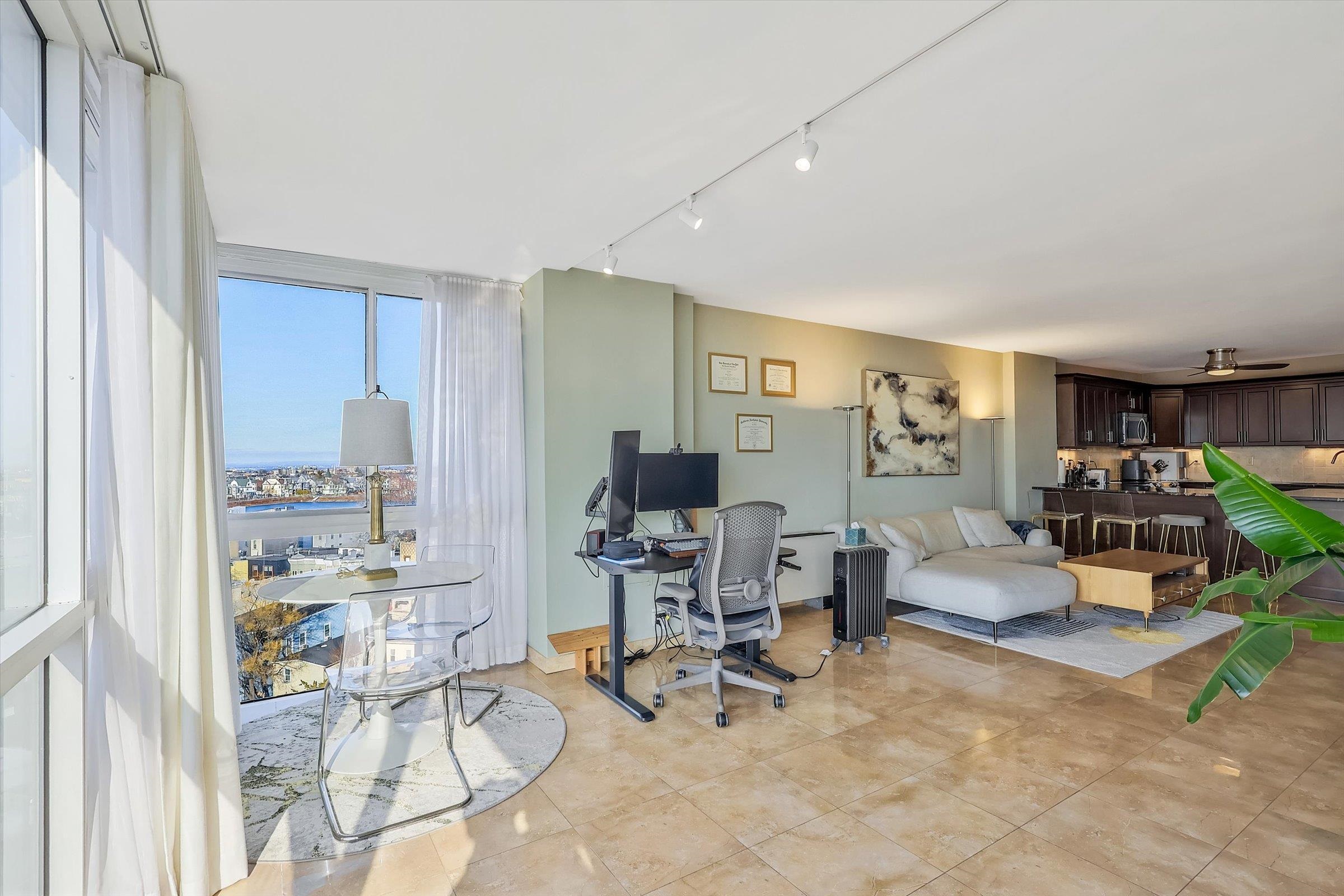 380 Mountain Road, Unit 1015 Union City, NJ 07087 - Photo 10 of 43 a living room with furniture and a kitchen area