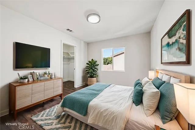 a bedroom with a bed and a flat screen tv