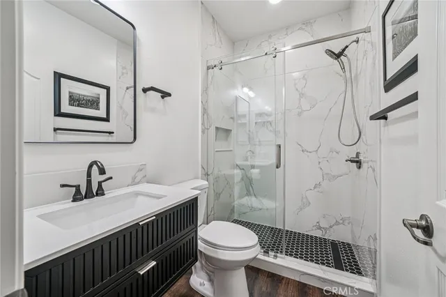 a bathroom with a sink toilet and shower