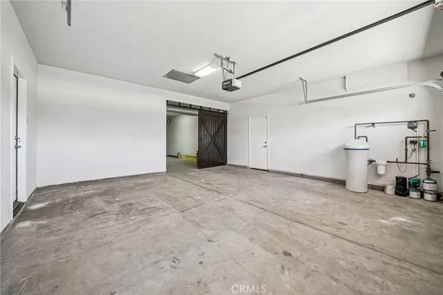 a view of a livingroom with a ceiling fan & entryway