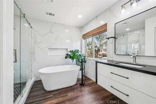 a white bath tub sitting next to a white sink
