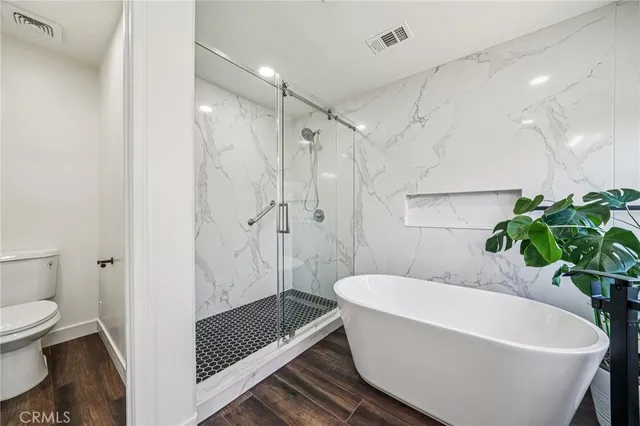 a white bath tub sitting next to a toilet