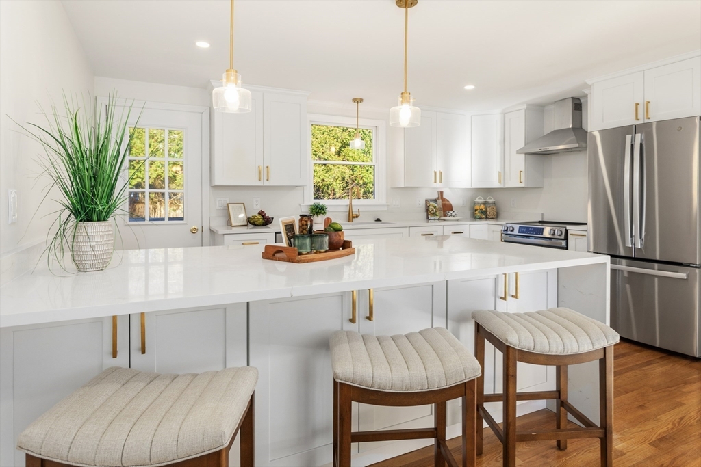 a kitchen with a table chairs refrigerator and microwave