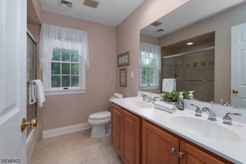 110 Orchard Road Skillman, NJ 08558 - Photo 30 of 43 a bathroom with a double vanity sink toilet and mirror