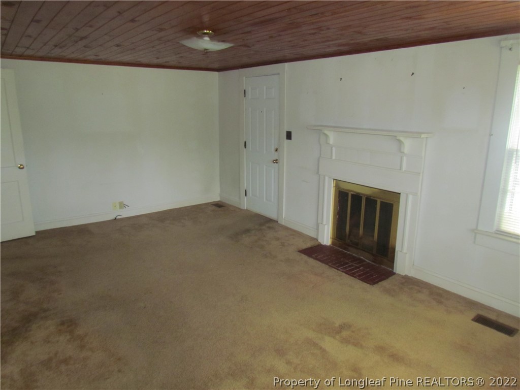 1635 Wade-Stedman Road Stedman, NC 28391 - Photo 13 of 23 an empty room with a fireplace