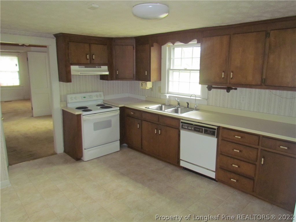 1635 Wade-Stedman Road Stedman, NC 28391 - Photo 6 of 23 a kitchen with sink a stove and cabinets