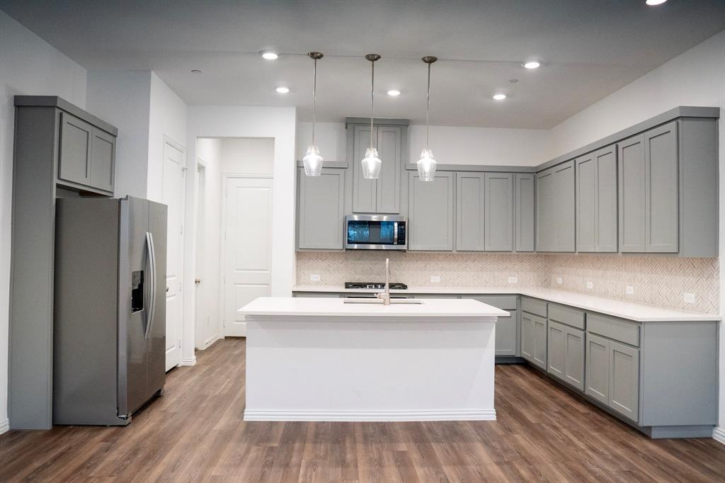 a kitchen with a sink stainless steel appliances and cabinets