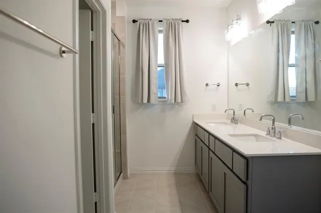 a bathroom with a double vanity sink a and a mirror