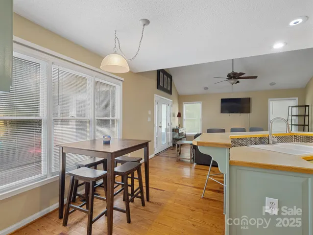 a dining room with a wooden table and chairs