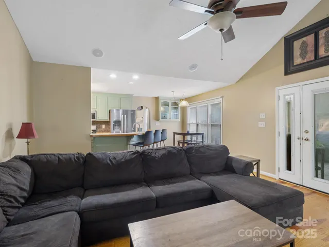 a living room with furniture and a ceiling fan