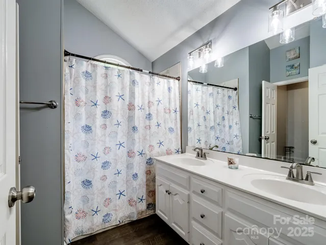 a bathroom with a double vanity sink and a mirror