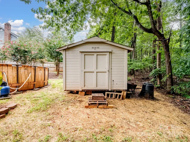 a backyard of a house with table and chairs