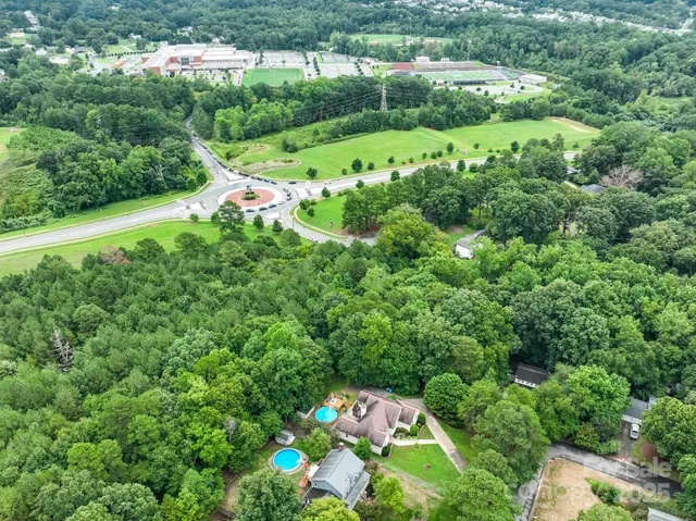 an aerial view of residential houses with outdoor space and street view