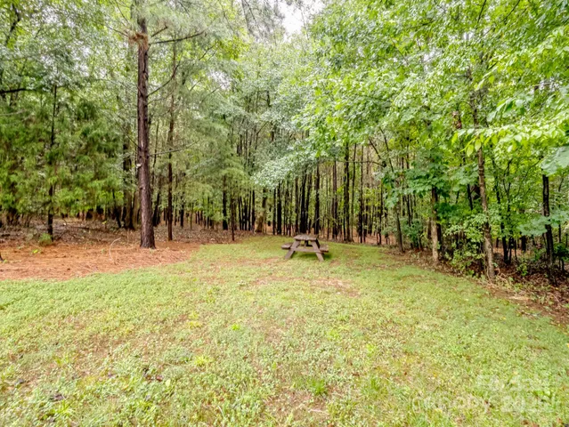 a backyard of a house with lots of trees