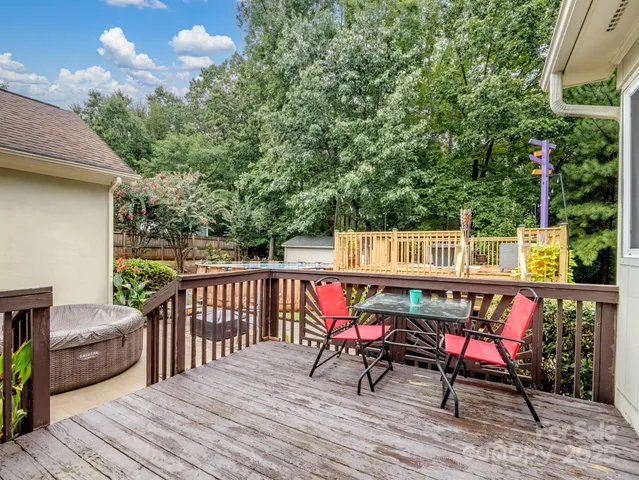 a view of a chairs and table on the wooden deck
