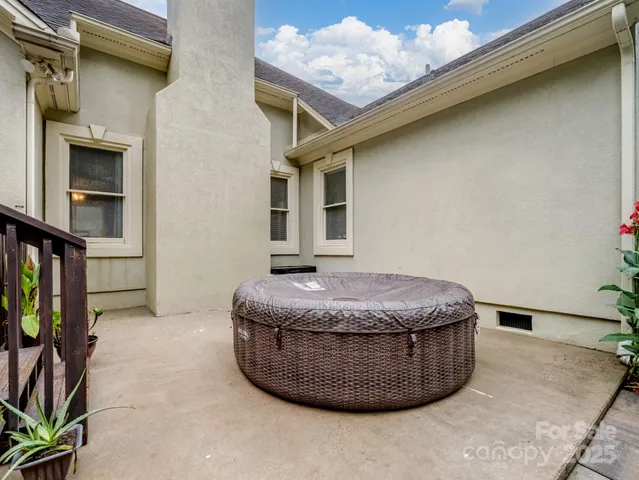 a view of a house with backyard and sitting area