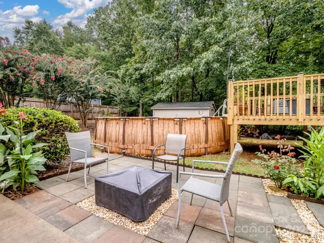 a roof deck with a table and chairs