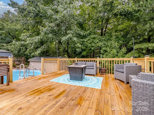a balcony with wooden floor and furniture