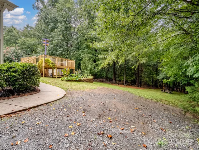a view of a backyard with large trees