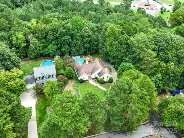 an aerial view of a house with a yard and outdoor seating