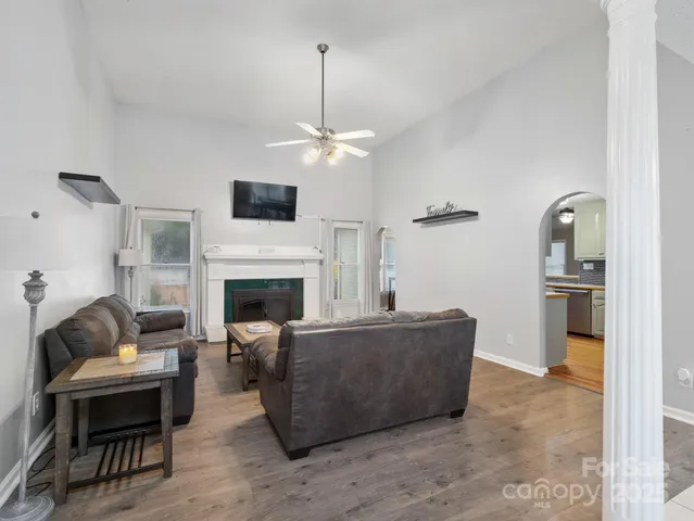a living room with furniture a fireplace and a flat screen tv