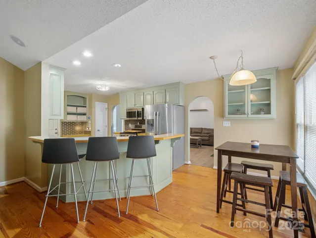 a living room with furniture a dining table and chairs