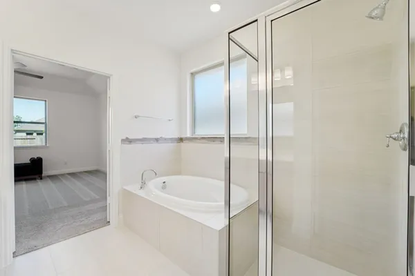 a bathroom with a bathtub and a shower