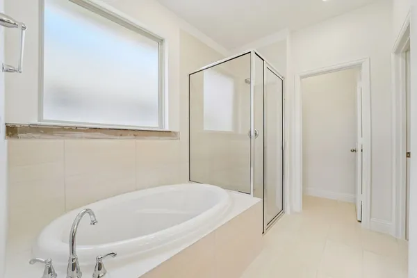 a bathroom with a tub and shower