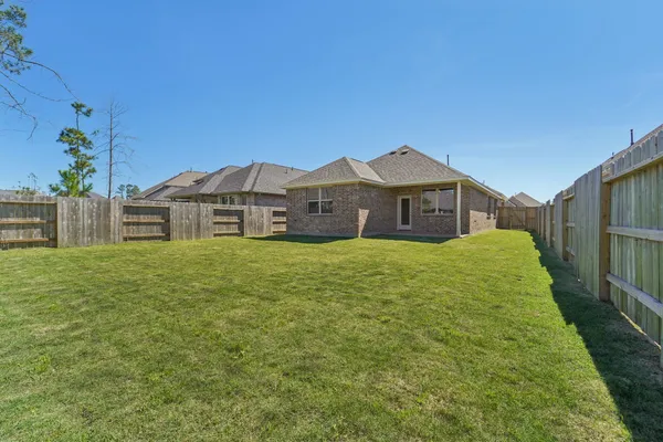 a large house with a big yard and large trees