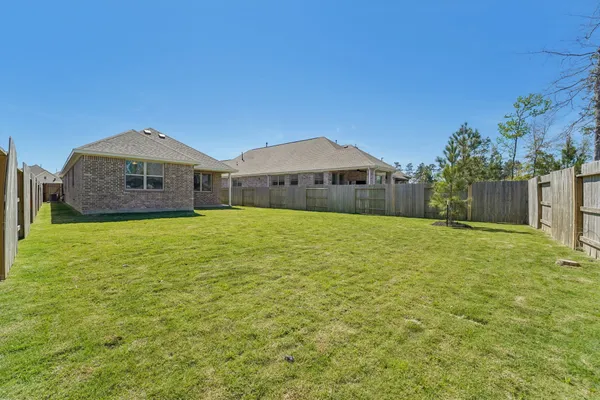 a large house with a big yard and large trees