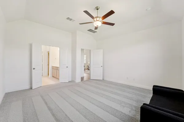 a view of a livingroom with a ceiling fan and wooden floor
