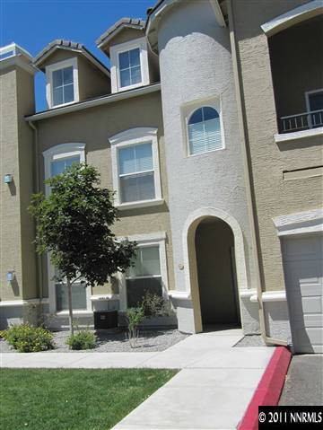9050 Double R Boulevard Reno, NV 89511 - Photo 2 of 13 a front view of a house with a garden