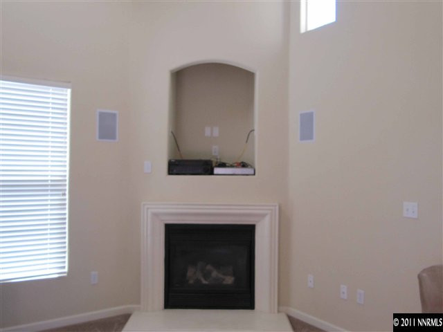9050 Double R Boulevard Reno, NV 89511 - Photo 5 of 13 a living room with a fireplace and a window