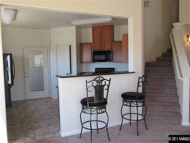 9050 Double R Boulevard Reno, NV 89511 - Photo 6 of 13 a kitchen with stainless steel appliances a refrigerator and a stove top oven