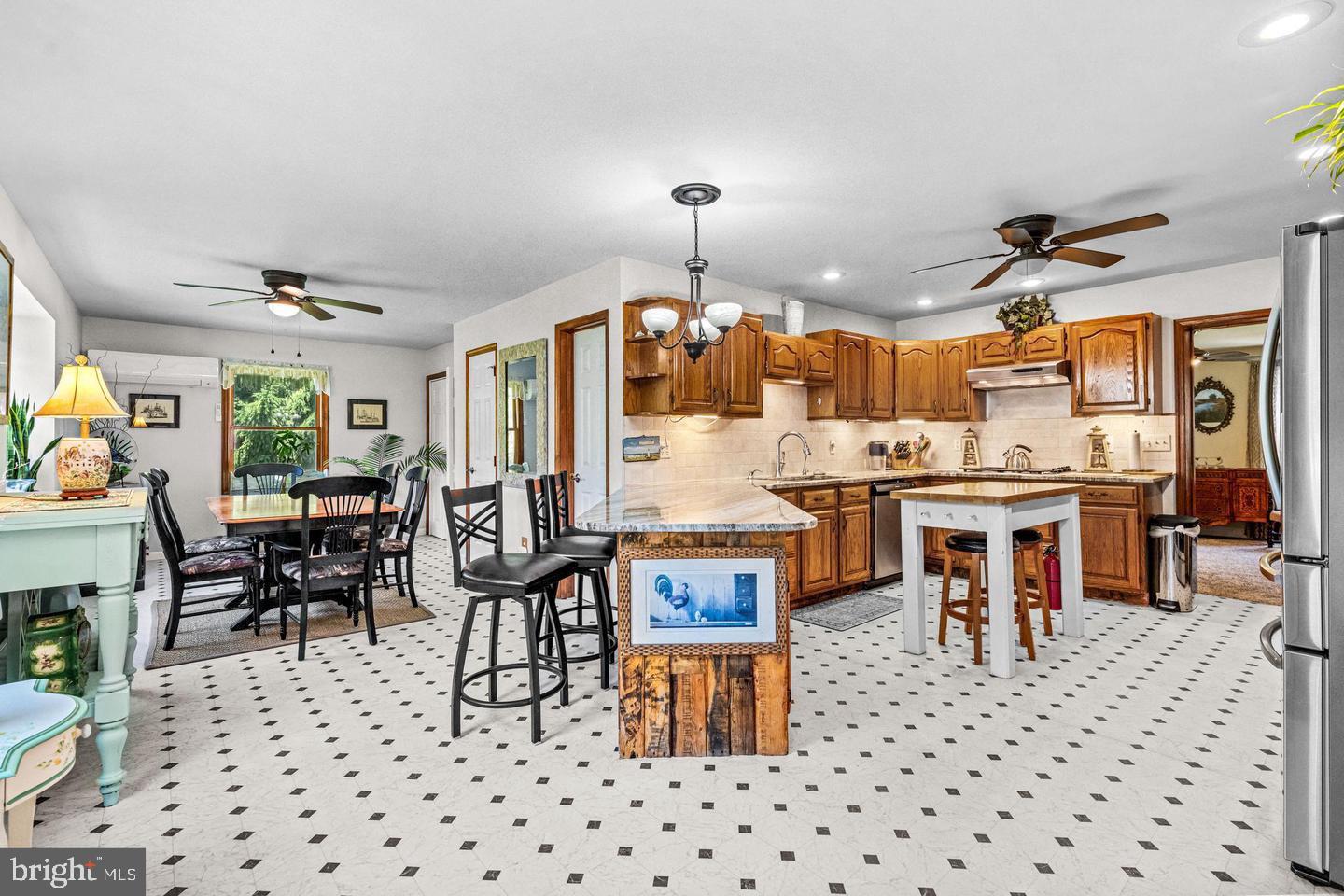 668 Crawford Road Cape May, NJ 08204 - Photo 18 of 66 a living room with stainless steel appliances kitchen island granite countertop a dining table chairs and a sink