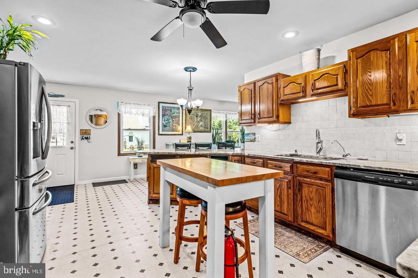668 Crawford Road Cape May, NJ 08204 - Photo 21 of 66 a kitchen with stainless steel appliances granite countertop a sink a stove and a refrigerator
